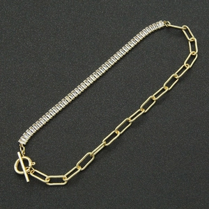 Detailed macro view of 18K gold bracelet featuring cubic zirconia and OT toggle closure
