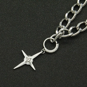 Macro shot of a silver Cuban chain necklace featuring a sparkling star pendant with zircon