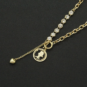 Macro view of gold chain necklace with sparkling crystals and vintage coin pendant