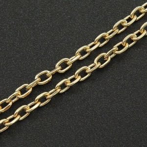 Macro view of polished gold oval link chain showing detailed craftsmanship on black background