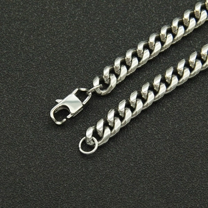 Detailed close-up of a silver stainless steel Cuban link necklace with a lobster clasp
