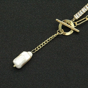 Detail of gold OT toggle clasp and baroque pearl pendant on a link chain necklace