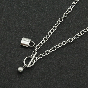 Macro view of silver titanium steel chain with OT buckle and rectangle lock pendant