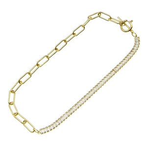 Golden paperclip chain bracelet with baguette-cut zircon stones and toggle clasp