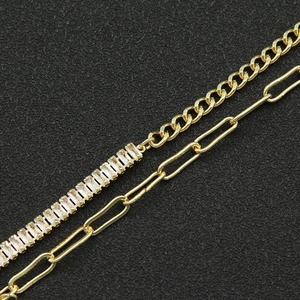 Detail of gold double-layer chain with baguette-cut zircons and paperclip links