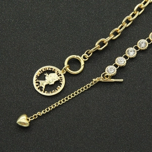 Gold layered necklace with portrait coin pendant and sparkling crystal accents