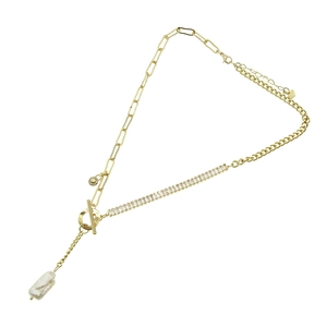 Minimalist gold necklace featuring mixed metal chains, baroque pearl and zirconia pendant