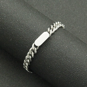 Polished silver Cuban link bracelet with blank oval ID plate on black display