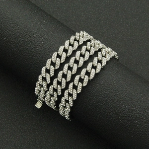 Detail of silver paved Cuban link chain with sparkling rhinestones on black display