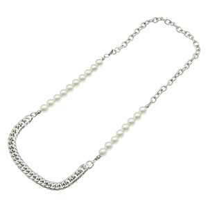 Detail of asymmetric necklace featuring pearl beads and silver curb chain elements