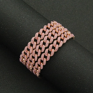 Detail of rose gold iced out Cuban link chain featuring multiple rows of pink rhinestones