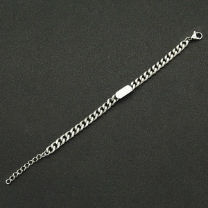 Detailed view of polished stainless steel Cuban chain bracelet with customizable ID plate