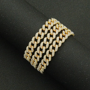 Close-up of gold-plated iced out Cuban link chain with detailed micro pave setting
