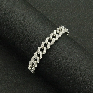 Detailed view of silver Cuban link bracelet with sparkling rhinestones on black display