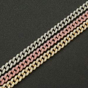 Iced out Cuban link chains in gold, silver, and rose pink for hip-hop fashion styling