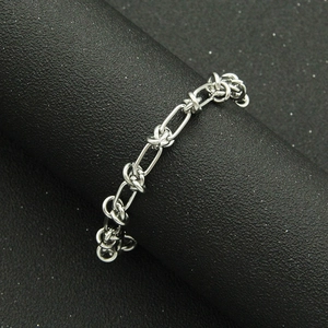 Minimalist silver chain link ring with industrial style geometric knot design