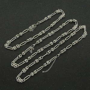 Industrial style silver chain bracelet with oval links and lobster clasp on black background