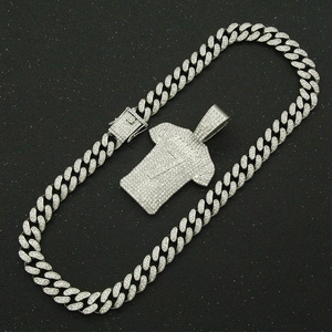 Macro shot of silver hip hop necklace with iced out jersey pendant and cuban chain