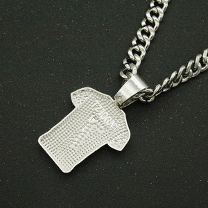 Macro shot of silver-toned hip hop jersey pendant back on chunky Cuban link chain