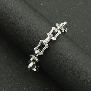 Polished silver dragon bone link bracelet for men on a black display stand