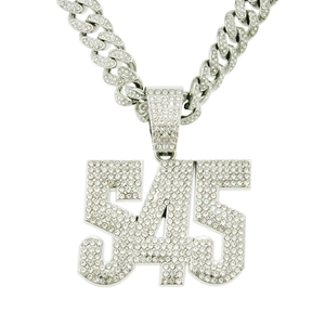 Detailed view of silver iced-out 545 number pendant with sparkling Cuban link chain