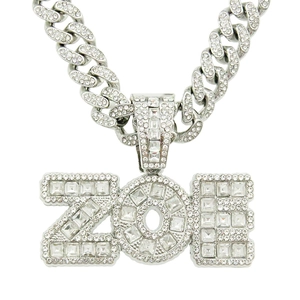 Detail of silver ZOE hip-hop pendant with iced-out crystals on a Cuban link chain