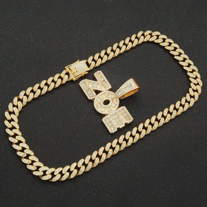 Iced out gold Cuban link chain with sparkling rhinestone encrusted NOE letter pendant