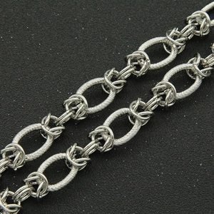 Chunky retro silver chain necklace featuring textured links and a knot clasp detail