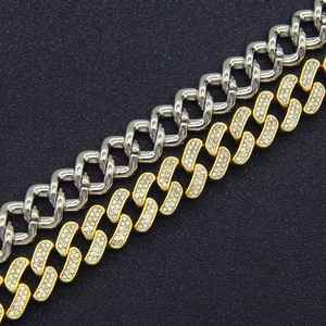 Détails macro de la chaîne cubaine en or sertie de diamants et maillons argentés