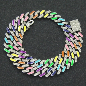 Macro detail of iced-out Cuban link chain with colorful enamel drip and diamond clasp