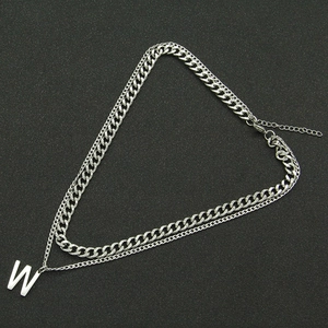 Double-layered silver Cuban chain necklace featuring a minimalist letter W pendant design