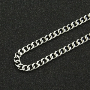 Macro shot of silver-toned polished stainless steel curb chain with double-layer link detail
