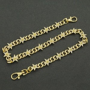 Detail of gold star chain link with rhinestones and metal lobster clasps for jeans