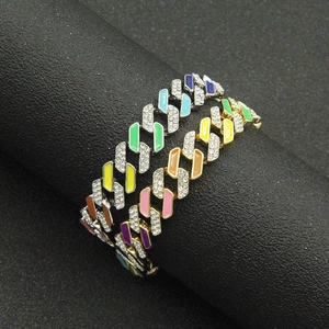 Rainbow Cuban link bracelets with diamonds and colorful enamel on a display stand