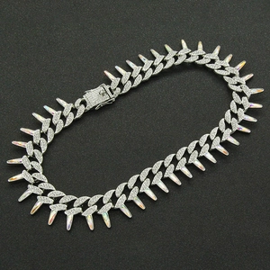 Macro detail of iced-out Cuban chain with iridescent spikes and secure box clasp closure