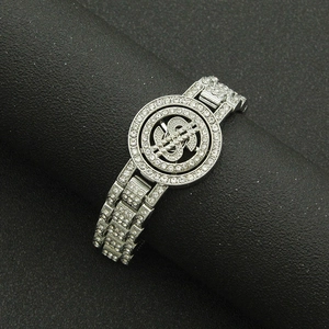 Close-up of iced out dollar sign watch band bracelet with sparkling crystal inlay