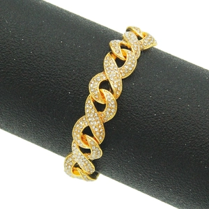 Macro shot of gold Cuban link chain with detailed white diamond pave setting on black stand