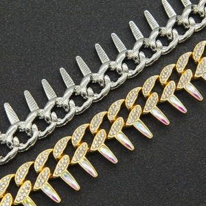 Macro shot of hip hop Cuban link bracelets with spikes and pavé iced out crystals