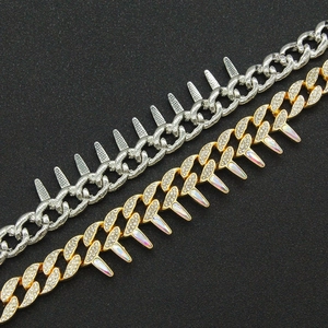 Close-up of hip hop cuban chain bracelets in gold and silver with sparkling spiked charms