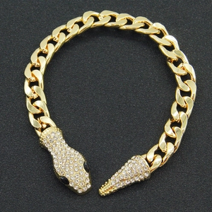 Golden snake head Cuban link bracelet encrusted with sparkling white cubic zirconia crystals