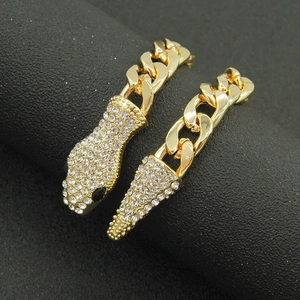 Gold Cuban chain earrings with pointed crystal pavé charms in a luxury geometric style