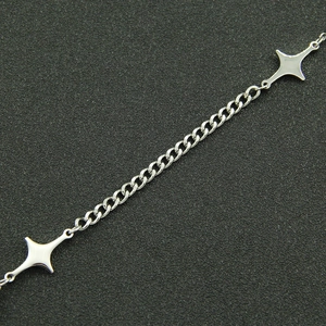 Close-up of polished silver star pendants on a titanium steel link chain necklace