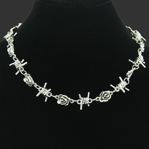 Gothic silver rose and thorn necklace on a black velvet mannequin for women