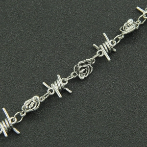 Retro punk style necklace with alternating silver rose flower and barbed wire chain links