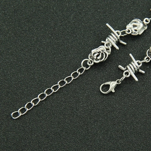 Detail of vintage silver rose pendant with thorn wire and adjustable lobster clasp