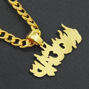 Macro shot of gold cuban chain with oversized flame-styled graffiti letter pendant