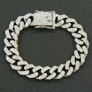 Close-up of silver Cuban link bracelet with pavé-set rhinestones and a secure buckle