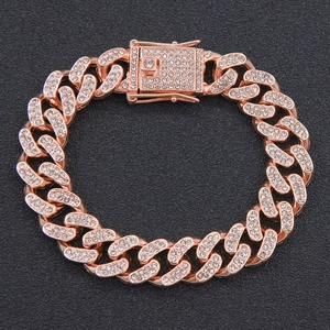 Macro shot of rose gold Miami Cuban link bracelet with iced out crystals and box clasp