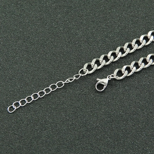 Detailed macro of silver Cuban chain necklace with secure lobster clasp and extender links