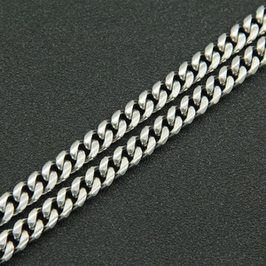 Detailed close-up of polished silver Cuban link chain with thick metallic links